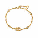 Gold-tone chain bracelet with a stone-set letter motif, two pearl-style beads and round clear-stone accents. White background.