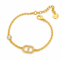 Gold-tone chain bracelet with a stone-set letter motif and a single round clear-stone accent. White background.