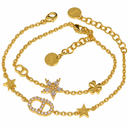 Two gold-tone bracelets: one with a stone-set oval letter motif and star details; one with a clear-stone flower, a clover and a polished letter motif. Includes both bracelets pictured. White background.