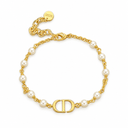 Gold-tone bracelet with spaced pearl-style beads and a polished letter motif. White background.