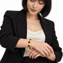 Female model wearing the gold and black 925 Clover Bracelet – Luminity London