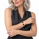 Female model wearing the gold and black Clover Bracelet – Luminity London