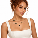 Female model wearing the gold and black 5 Clover Necklace – Luminity London